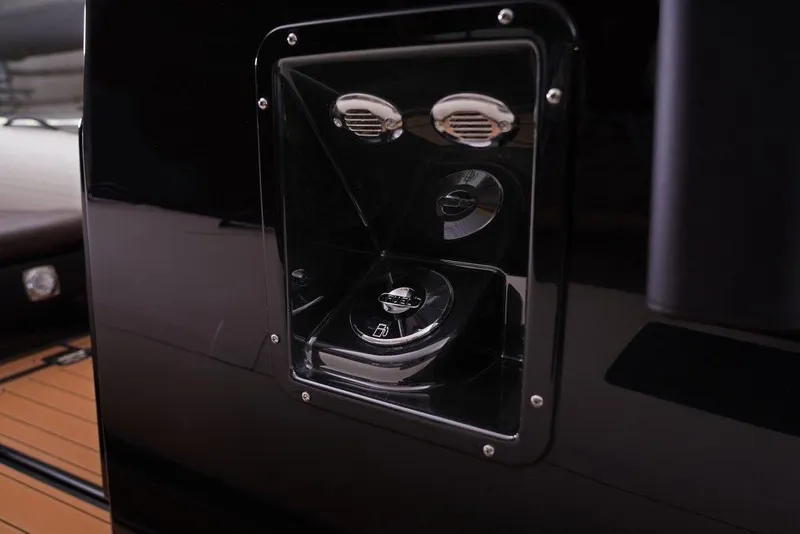 Slide: The Image of 2026 Brig Navigator 22 boat dashboard with sleek black panel and control dials. - 14