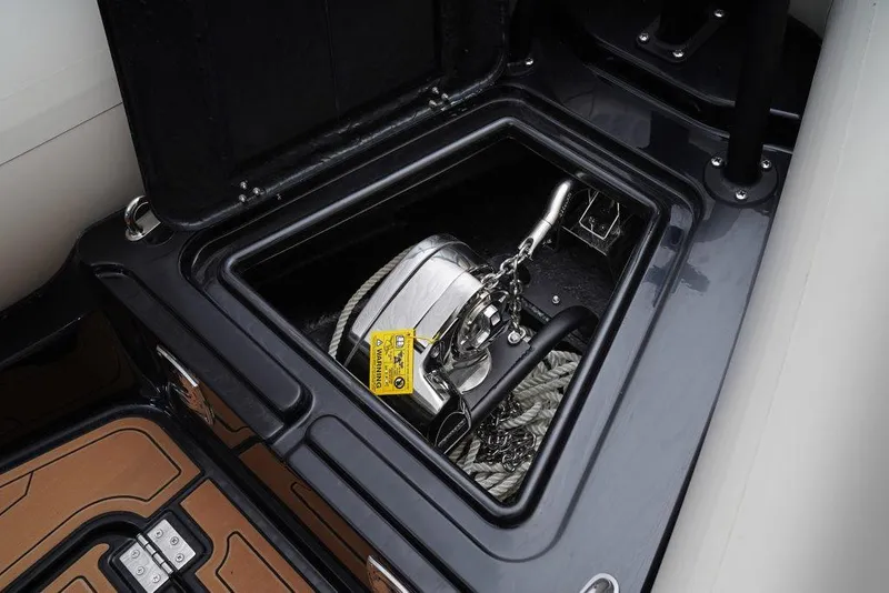 Slide: The Image of Anchor storage compartment on 2026 Brig Navigator 22 boat, featuring a neatly coiled rope and chain. - 19