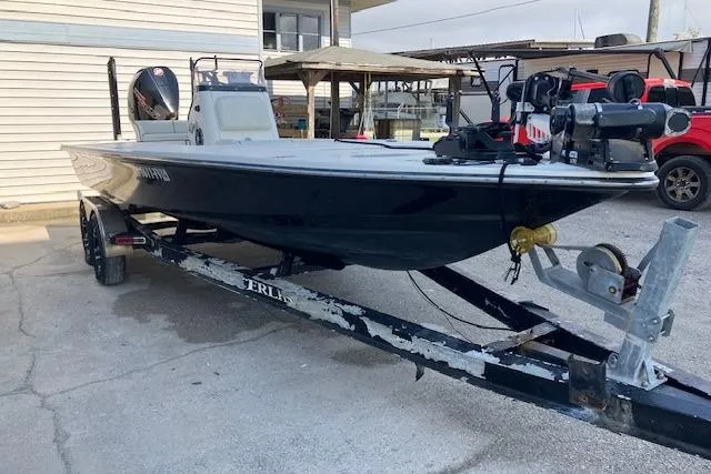 The Image of 2007 Dutch Sterling 22 boat on trailer, parked outdoors near a building. - 0