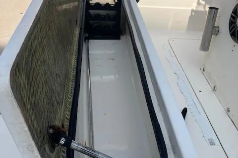 Slide: The Image of Open storage compartment on a 2007 Sterling 22-6 boat, featuring hydraulic support. - 10