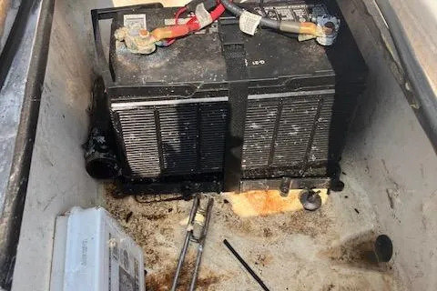 Slide: The Image of Battery compartment of a 2007 Sterling 22-6 with visible cables and tools. - 14