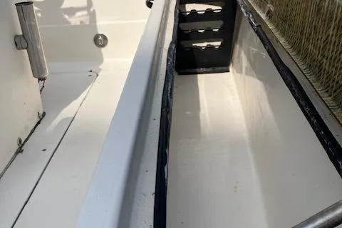 Slide: The Image of 2007 Sterling 22-6 boat interior with storage compartments and clean white finish. - 15