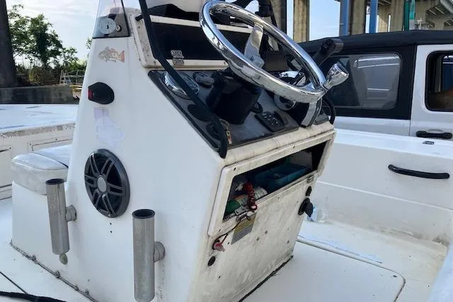 Slide: The Image of 2007 Dutch Sterling 22 boat console with steering wheel and storage compartment. - 7