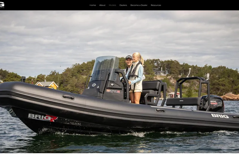 The Image of 2026 Brig Navigator 20 boat cruising on a scenic lake with two people onboard. - 1