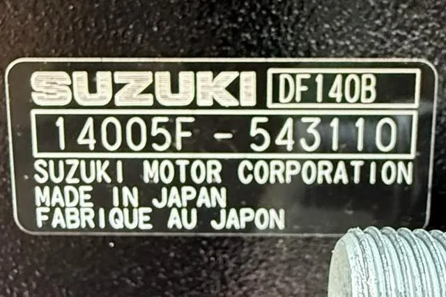 Slide: The Image of ```json { "alt_text": "Suzuki DF140B engine label, serial number 14005F-543110, made in Japan." } ``` - 10