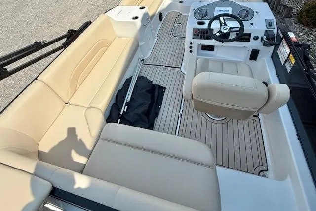 Slide: The Image of 2026 Hurricane FD198RE-OB boat interior with beige seating and modern dashboard. - 6