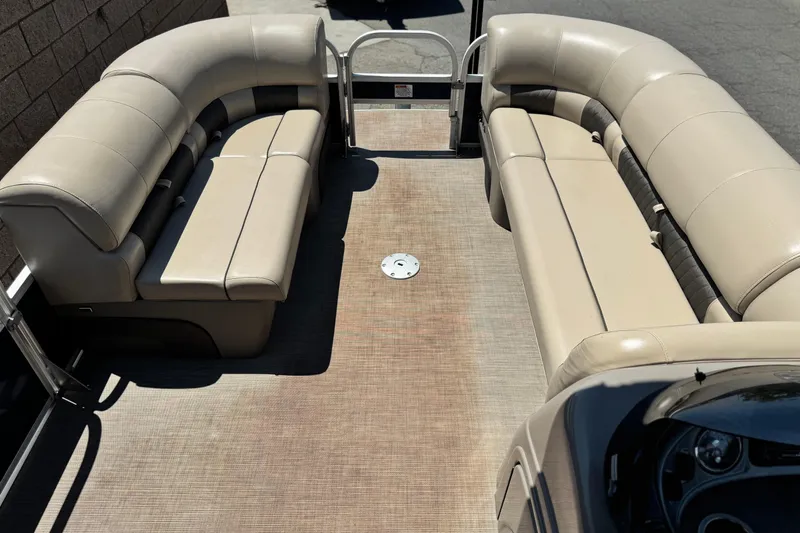 Slide: The Image of 2021 Sun Tracker SportFish 22 DLX pontoon boat interior with beige seating. - 10