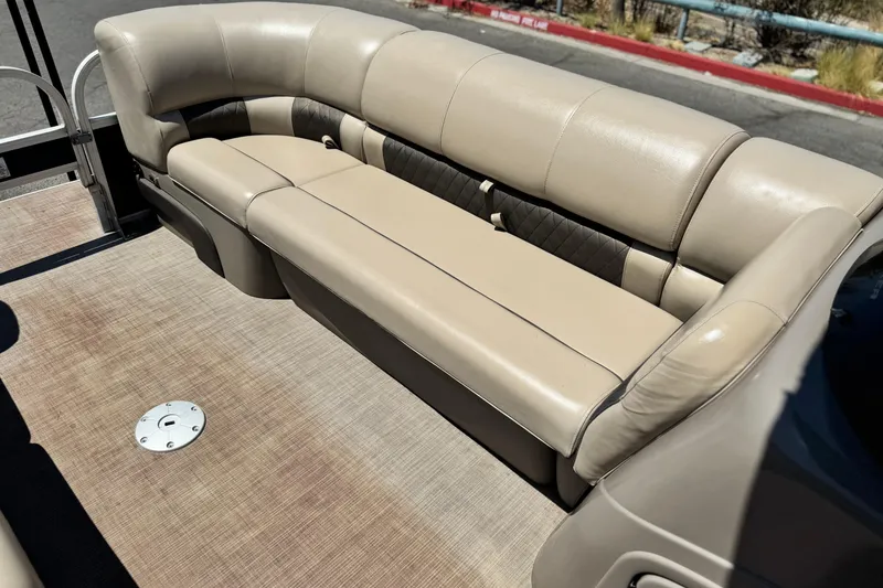 Slide: The Image of 2021 Sun Tracker SportFish 22 DLX boat interior with beige seating and flooring. - 12