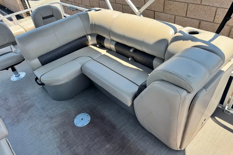 Slide: The Image of 2021 Sun Tracker SportFish 22 DLX pontoon boat with beige seating and cup holders. - 14