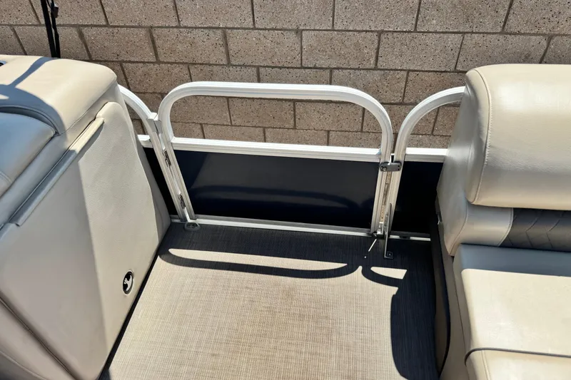 Slide: The Image of Interior of 2021 Sun Tracker SportFish 22 DLX pontoon boat, featuring seating and railing. - 15