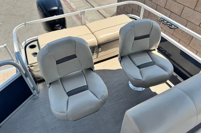 Slide: The Image of 2021 Sun Tracker SportFish 22 DLX boat interior with two swivel seats and motor. - 16