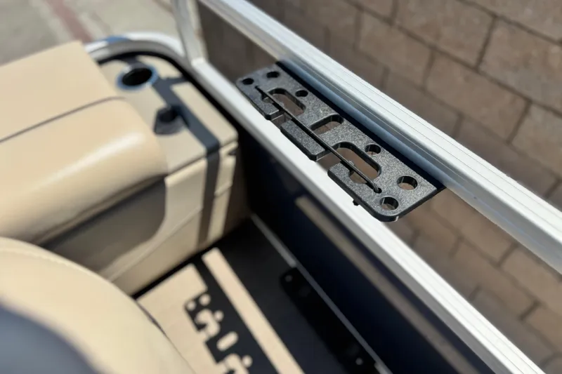 Slide: The Image of Interior view of 2021 Sun Tracker SportFish 22 DLX boat, featuring beige seating and metal bracket. - 17
