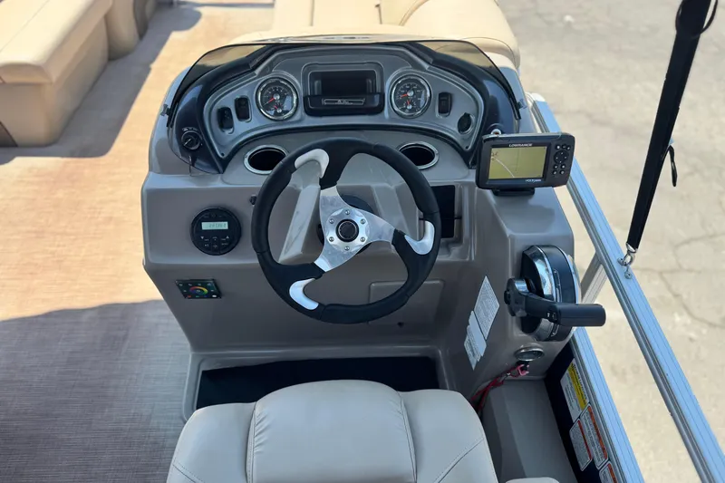 Slide: The Image of 2021 Sun Tracker SportFish 22 DLX boat dashboard with steering wheel and navigation system. - 24
