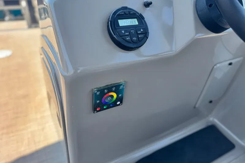 Slide: The Image of Control panel of 2021 Sun Tracker SportFish 22 DLX boat with audio and lighting controls. - 25