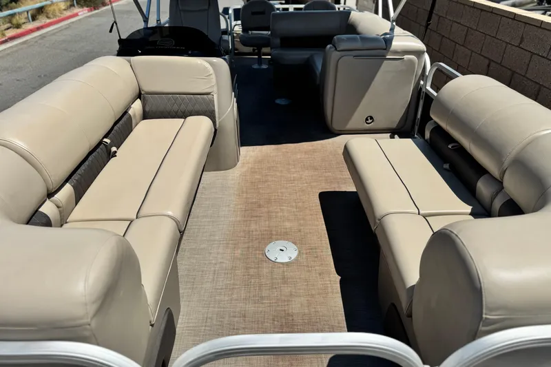Slide: The Image of 2021 Sun Tracker SportFish 22 DLX pontoon boat interior with beige seating and spacious layout. - 9