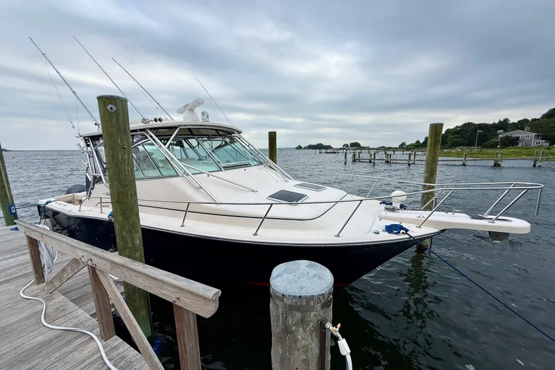 Slide: The Image of 2008 Grady-White Express 360 boat docked at a marina under cloudy skies. - 14
