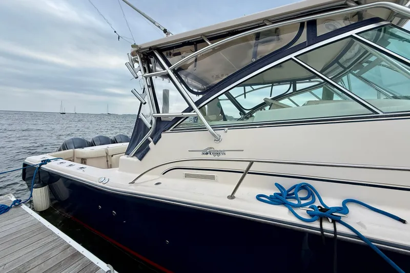 Slide: The Image of 2008 Grady-White Express 360 boat docked by the sea with blue ropes. - 16
