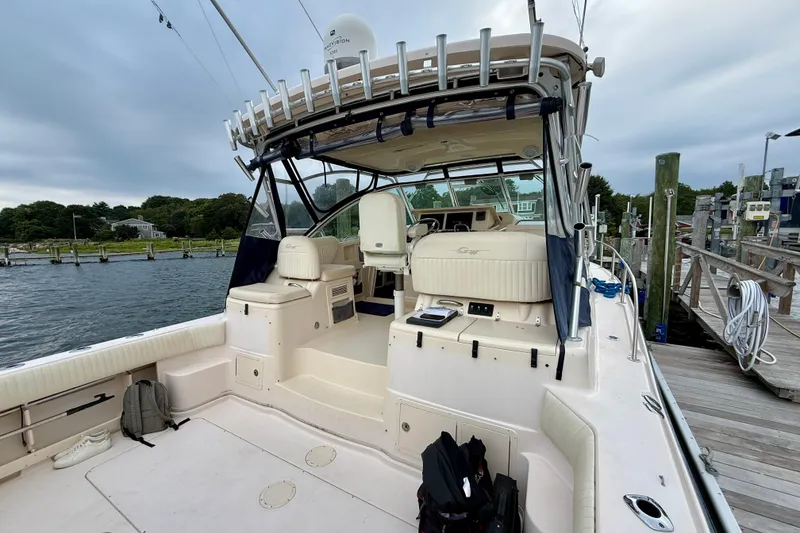 Slide: The Image of 2008 Grady-White Express 360 boat docked, featuring spacious deck and seating area. - 18