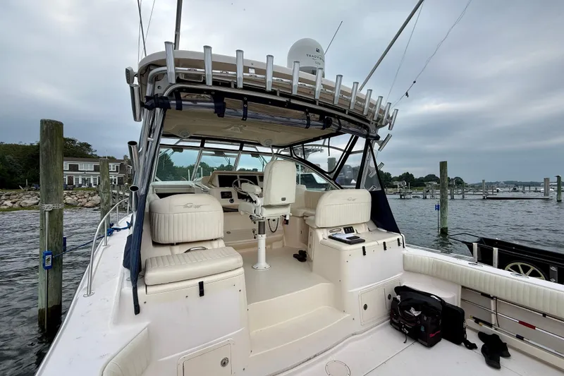 Slide: The Image of 2008 Grady-White Express 360 boat docked, featuring spacious seating and fishing equipment. - 19