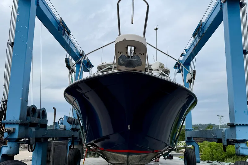 Slide: The Image of 2008 Grady-White Express 360 boat docked near a bridge under a partly cloudy sky. - 2