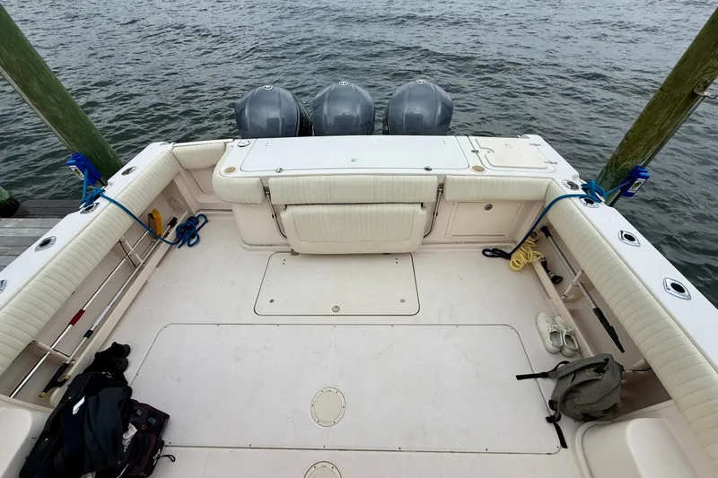 Slide: The Image of 2008 Grady-White Express 360 boat deck with triple outboard motors, docked by the water. - 20