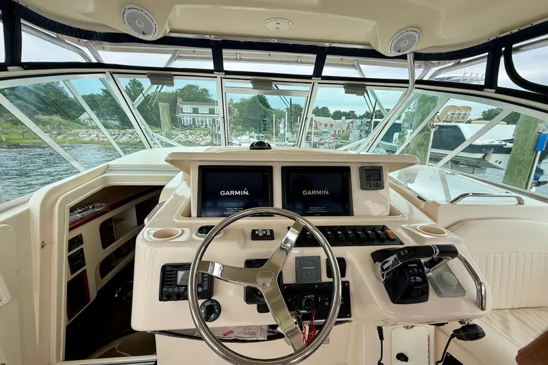 Slide: The Image of 2008 Grady-White Express 360 helm with Garmin navigation, docked by waterfront homes. - 21