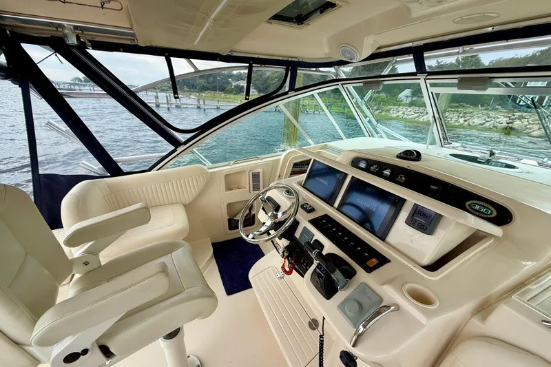 Slide: The Image of 2008 Grady-White Express 360 helm with Garmin displays, luxurious seating, and panoramic water view. - 5