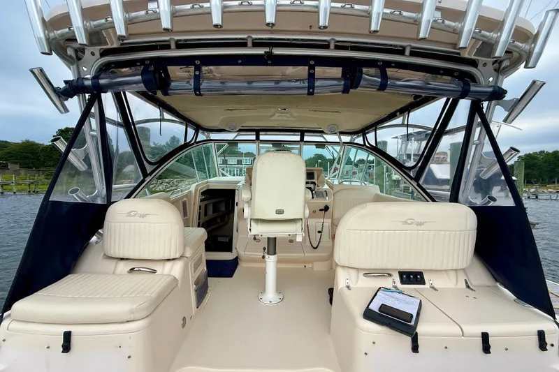 Slide: The Image of 2008 Grady-White Express 360 boat interior with seating and helm, docked by the water. - 7