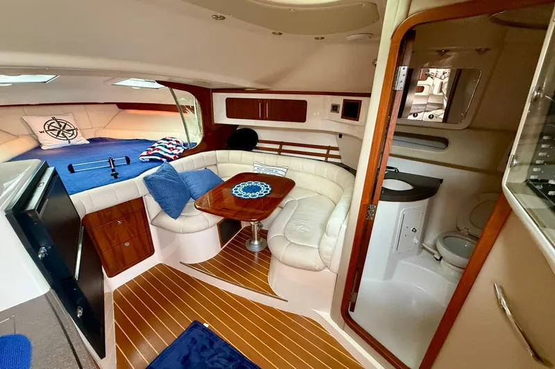 Slide: The Image of 2008 Grady-White Express 360 cabin interior with seating, table, and bathroom. - 9