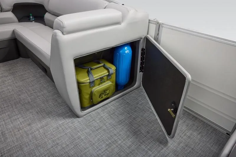 Slide: The Image of 2026 Sun Tracker Party Barge 20 DLX storage compartment with cooler and blue fender. - 26