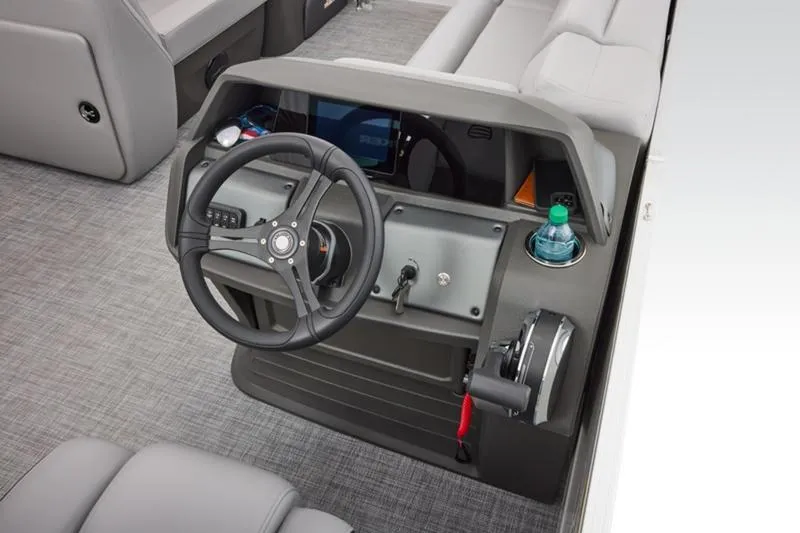 Slide: The Image of 2026 Sun Tracker Party Barge 20 DLX helm with steering wheel and controls. - 32