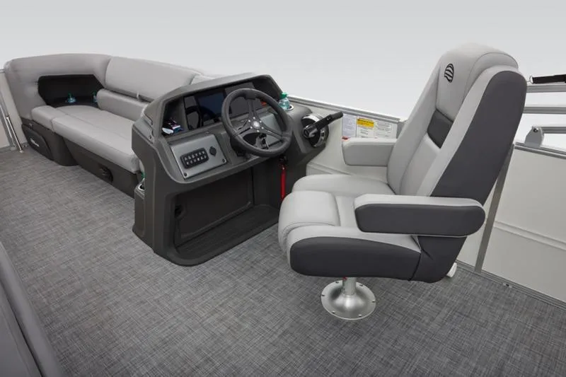 Slide: The Image of 2026 Sun Tracker Party Barge 20 DLX interior with captain's chair and control console. - 33