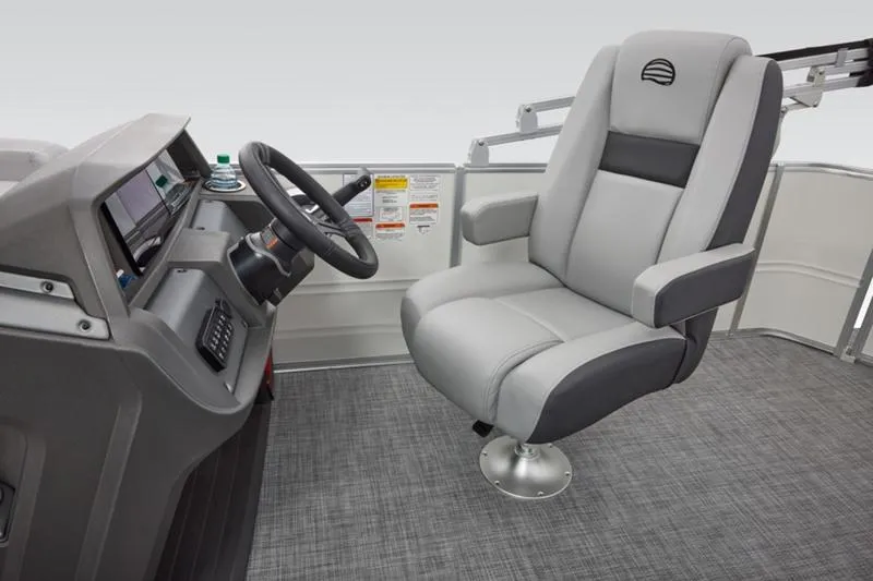 Slide: The Image of 2026 Sun Tracker Party Barge 20 DLX helm with comfortable captain's chair and modern controls. - 34