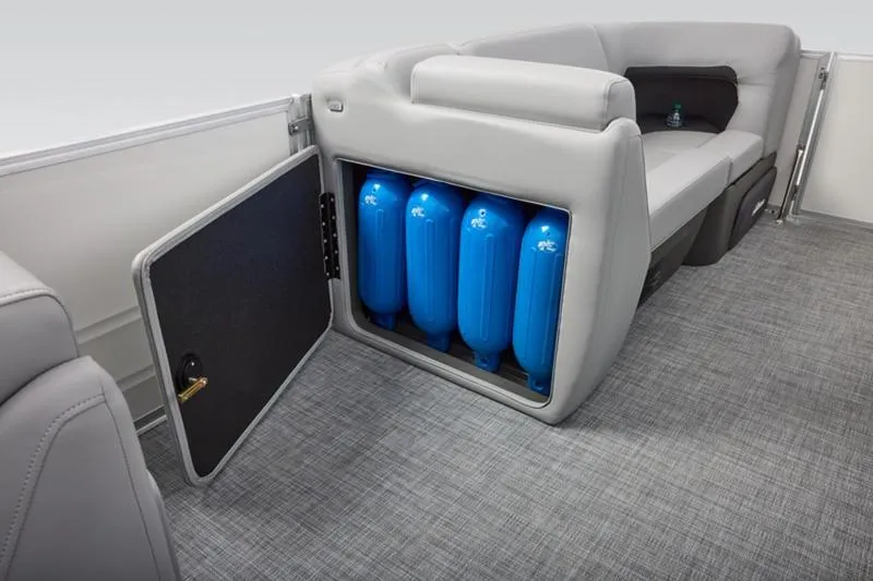 Slide: The Image of 2026 Sun Tracker Party Barge 20 DLX interior with storage compartment and blue fenders. - 38