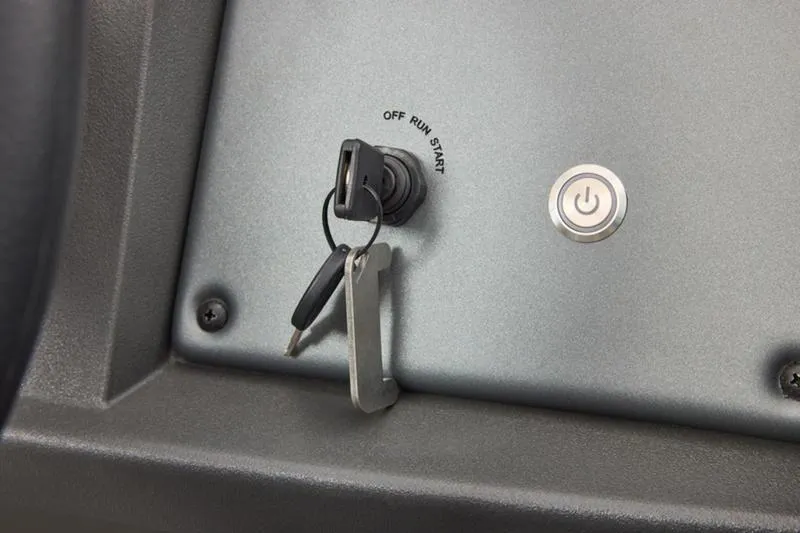 Slide: The Image of Ignition switch and power button on 2026 Sun Tracker Party Barge 20 DLX dashboard. - 46