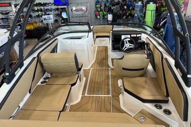 Slide: The Image of 2024 Sea Ray SPX 210 boat interior with tan seating and modern dashboard. - 12