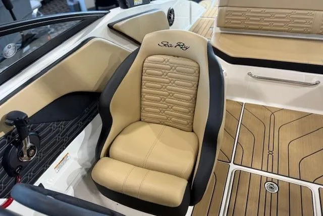 Slide: The Image of 2024 Sea Ray SPX 210 boat interior with beige seating and wood-style flooring. - 15