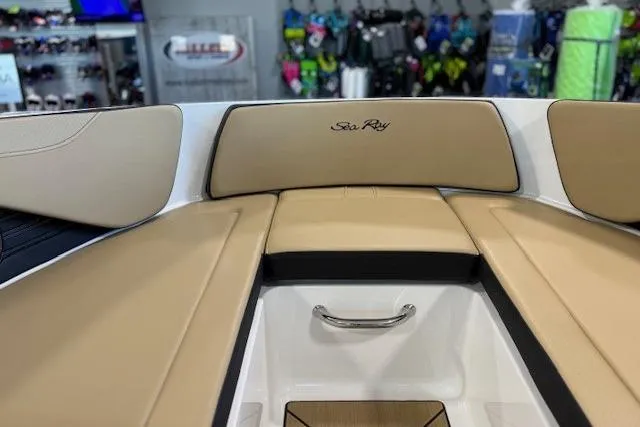 Slide: The Image of 2024 Sea Ray SPX 210 boat interior with tan seating and storage compartment. - 16