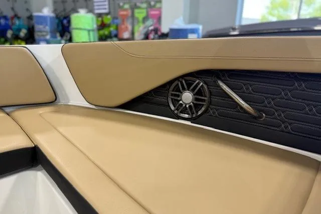 Slide: The Image of 2024 Sea Ray SPX 210 boat interior with tan upholstery and speaker detail. - 18
