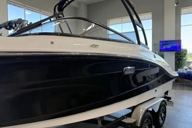 Slide: The Image of 2024 Sea Ray SPX 210 boat on trailer in showroom, side view. - 2