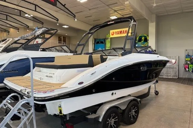 Slide: The Image of 2024 Sea Ray SPX 210 boat on display in showroom with trailer. - 4