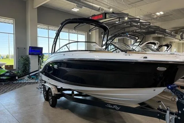 Slide: The Image of 2024 Sea Ray SPX 210 boat displayed indoors on a trailer. - 5