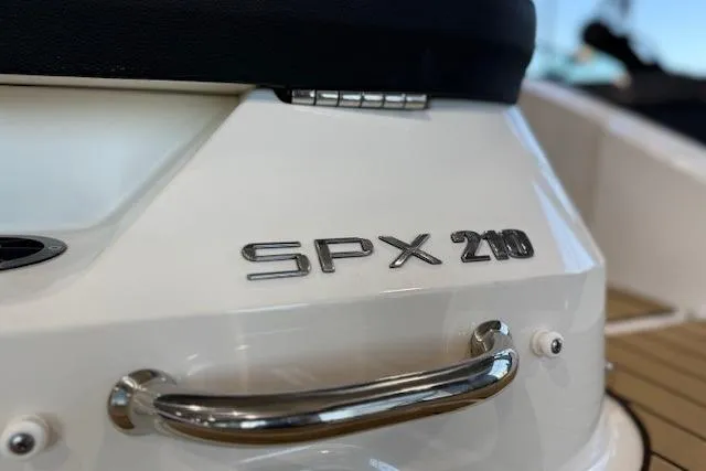 Slide: The Image of 2024 Sea Ray SPX 210 boat, close-up of model name and chrome handle. - 6