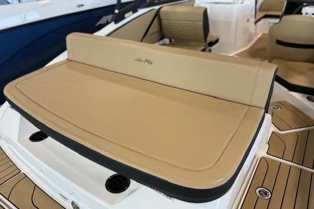 Slide: The Image of 2024 Sea Ray SPX 210 boat interior with tan seating and sleek design. - 8