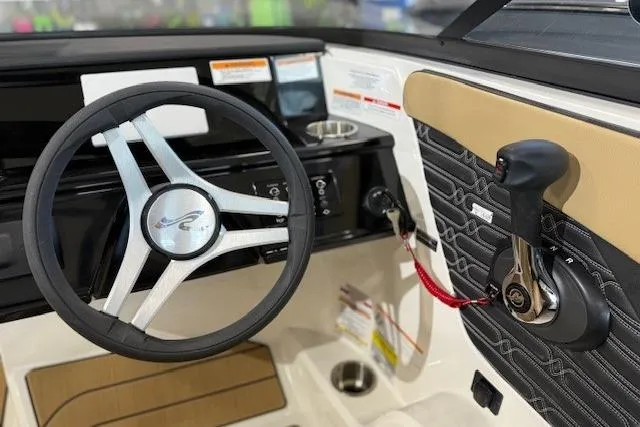 Slide: The Image of 2024 Sea Ray SPX 210 boat dashboard with steering wheel and throttle controls. - 9
