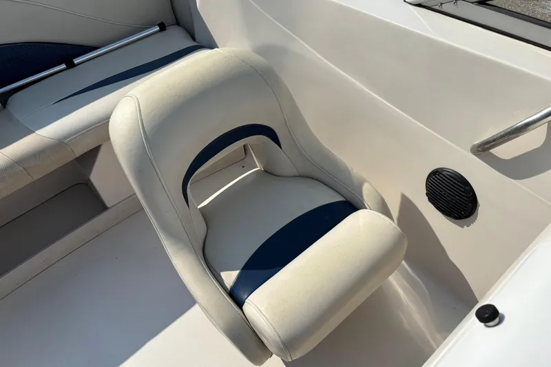 Slide: The Image of 2006 Starcraft C-Star 1800 I/O boat interior with white and blue seating. - 12