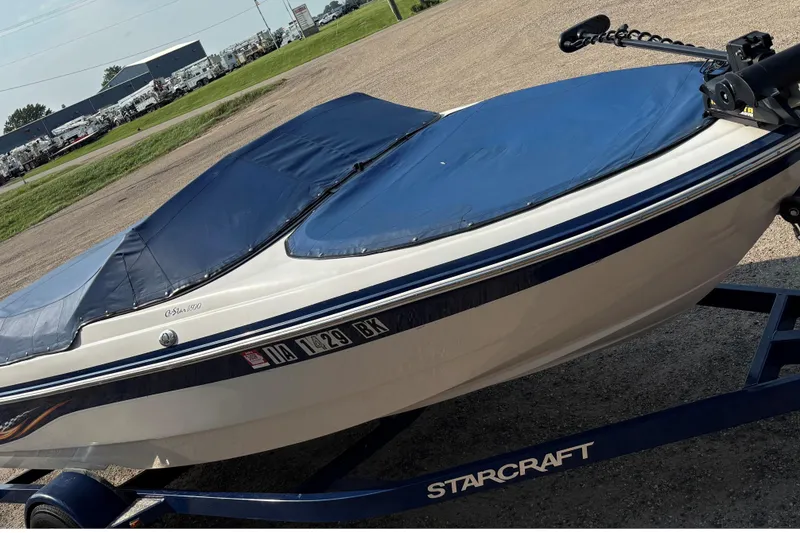 Slide: The Image of 2006 Starcraft C-Star 1800 I/O boat with blue cover on trailer. - 19