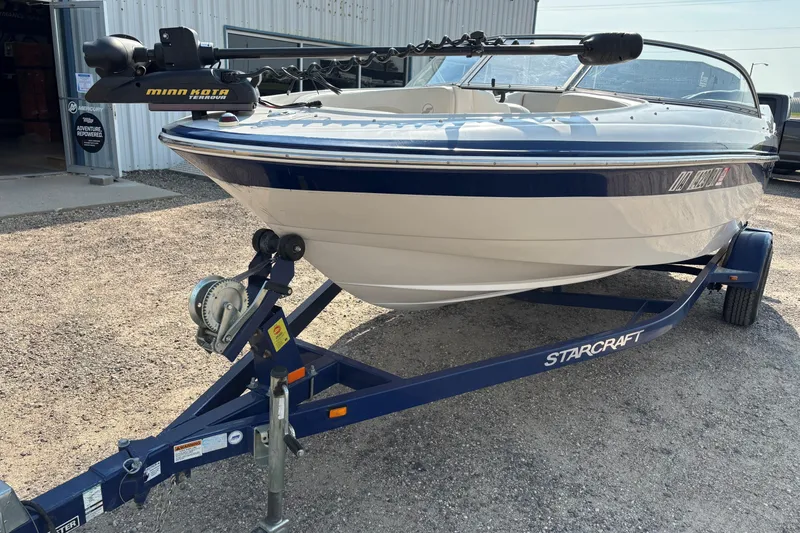 Slide: The Image of 2006 Starcraft C-Star 1800 I/O boat on trailer with Minn Kota trolling motor. - 2