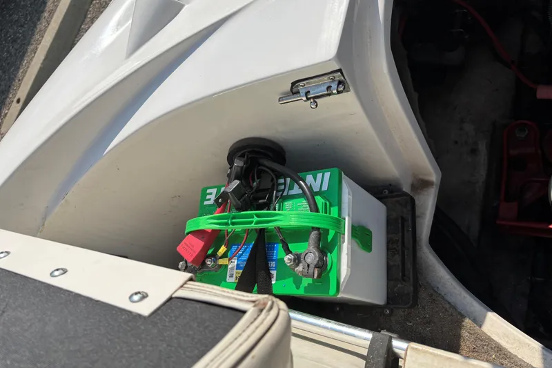 Slide: The Image of Battery compartment of a 2006 Starcraft C-Star 1800 I/O boat, featuring a green battery. - 8