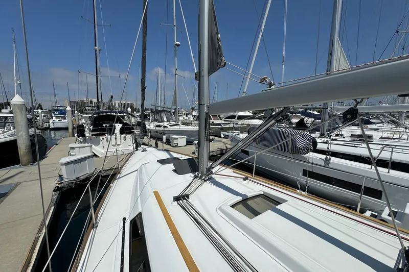 Slide: The Image of 2017 Beneteau Oceanis 37 sailboat docked at a marina under clear blue skies. - 11